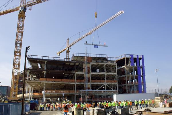 Employees gathered around a construction site. 